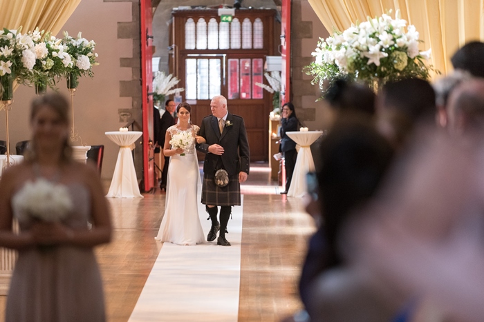 father and daughter walking down the aisle - image by Julie Tinton Photography 