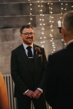The groom smiling during the exchange of vows in Mansfield Tranquair, Edinburgh