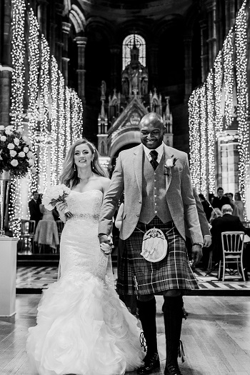 A happy bride and groom holding hands in Mansfield Tranquair, Edinburgh 