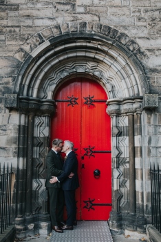The handsome newly wed couple kissing in front of Mansfield Tranquair, Edinburgh