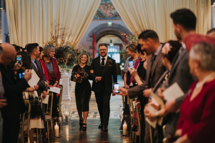 A happy groom walks down the aisle in Mansfield Tranquair, Edinburgh